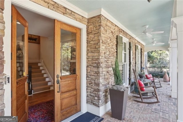 doorway to property featuring ceiling fan