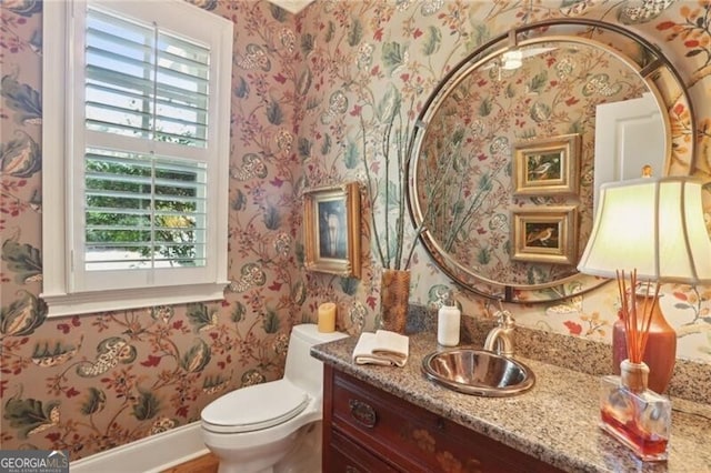 bathroom featuring vanity and toilet