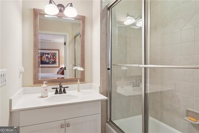 bathroom with enclosed tub / shower combo and vanity