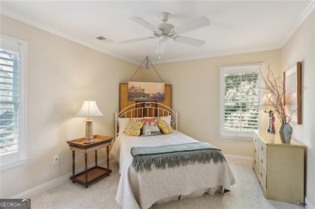 carpeted bedroom with multiple windows, ornamental molding, and ceiling fan