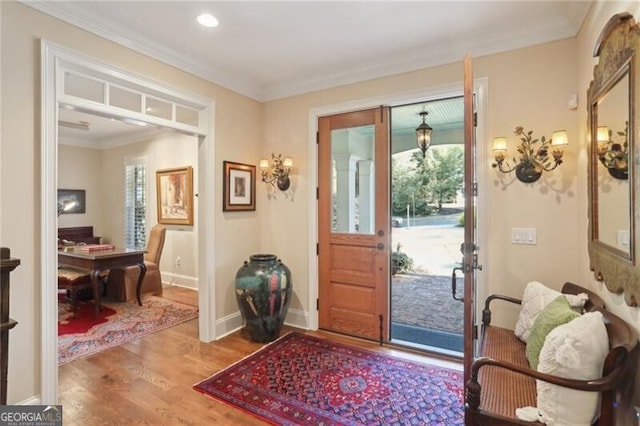 entryway with crown molding and wood-type flooring