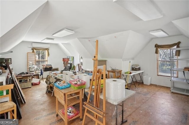 additional living space featuring lofted ceiling, a wealth of natural light, and an AC wall unit