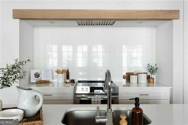 kitchen with decorative backsplash and stainless steel electric range