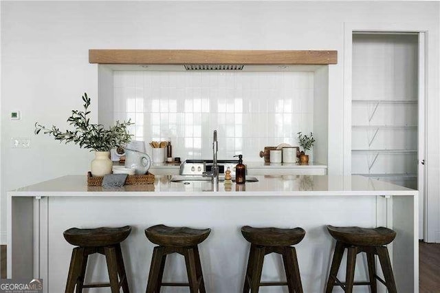 kitchen featuring a breakfast bar and sink