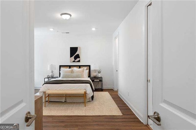 bedroom with dark wood-type flooring