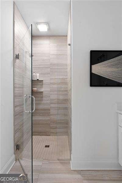 bathroom featuring a shower with shower door