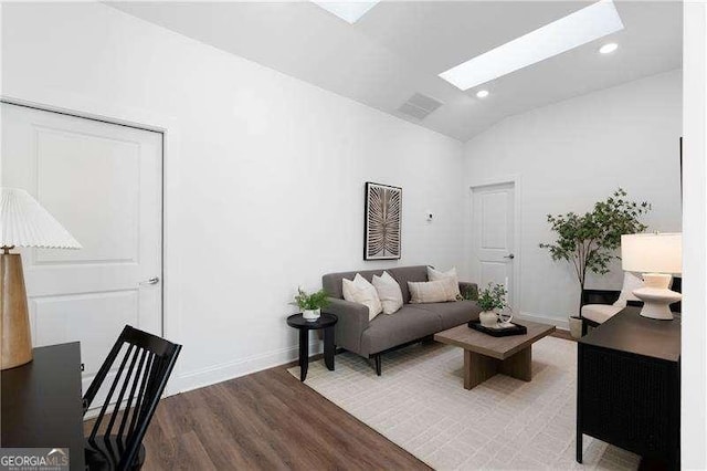 living room with lofted ceiling with skylight and hardwood / wood-style floors