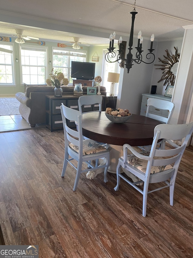 dining space with ornamental molding, a textured ceiling, ceiling fan, and wood finished floors