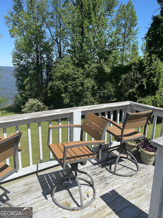wooden deck featuring a lawn