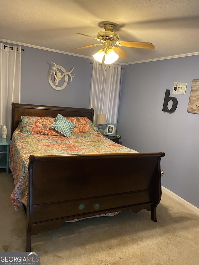 bedroom featuring baseboards, crown molding, ceiling fan, and carpet floors