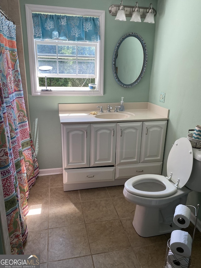 bathroom with tile patterned floors, toilet, a shower with shower curtain, and vanity