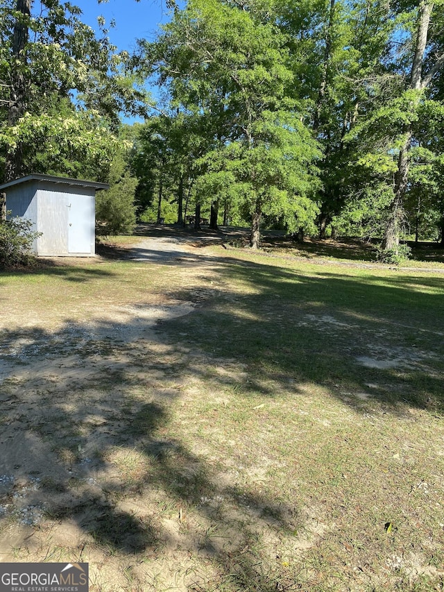 view of yard featuring an outbuilding and a storage shed