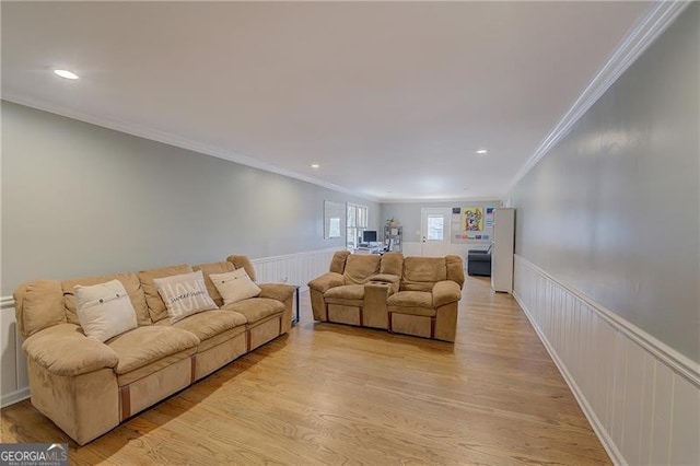 living room featuring crown molding and light hardwood / wood-style flooring