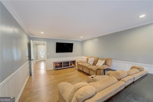 living room with crown molding and light hardwood / wood-style floors