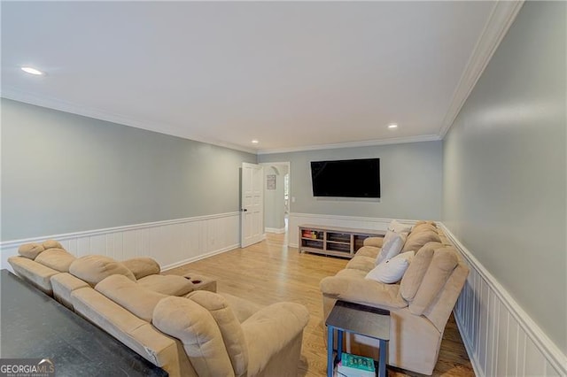 living room with hardwood / wood-style floors and crown molding