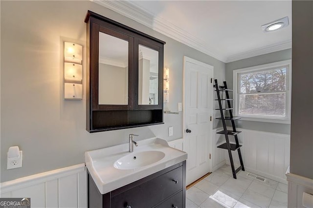 bathroom featuring crown molding and vanity