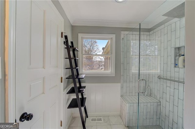 bathroom with ornamental molding and a shower with shower door