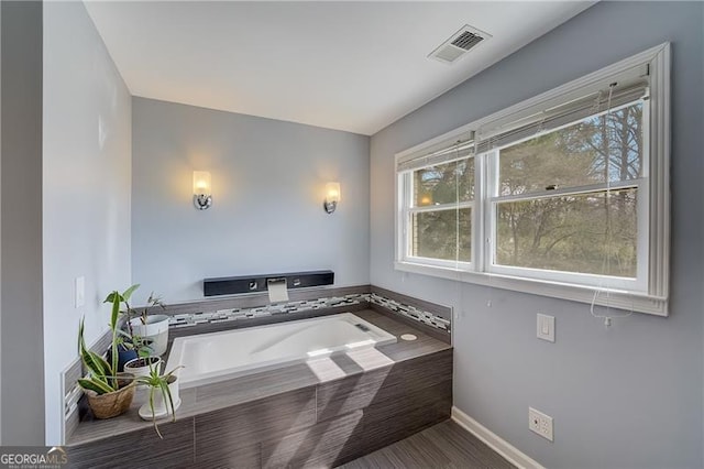 bathroom with tiled bath