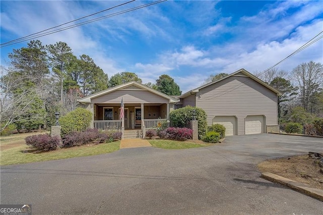 view of front of property featuring a garage and covered porch