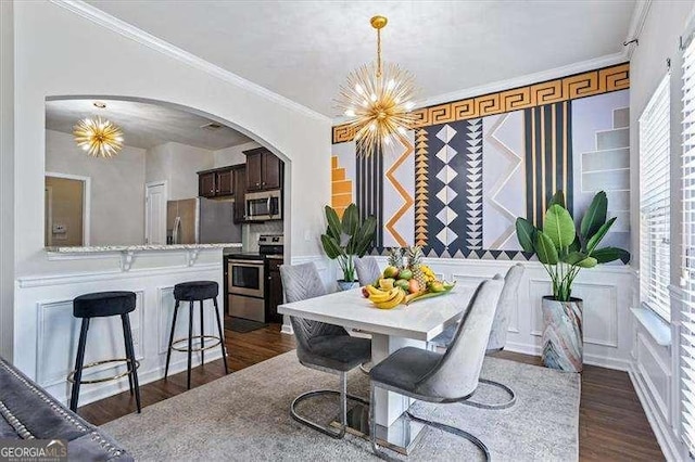 dining space featuring crown molding, a notable chandelier, and dark hardwood / wood-style flooring