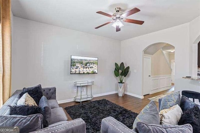 living room with hardwood / wood-style flooring and ceiling fan