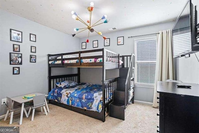 carpeted bedroom featuring a notable chandelier