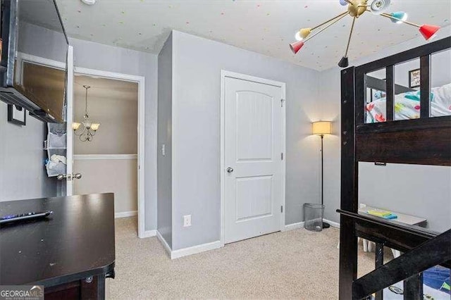 bedroom with light colored carpet and a chandelier