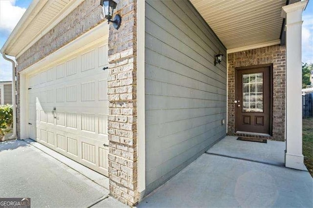 doorway to property featuring a garage