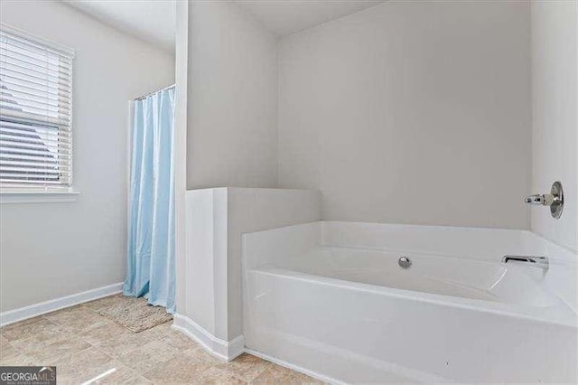 bathroom featuring a washtub