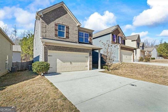 view of property with a garage, a front lawn, and central air condition unit