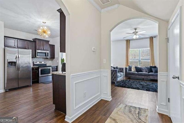 kitchen with dark wood-type flooring, dark brown cabinets, ceiling fan, stainless steel appliances, and decorative backsplash