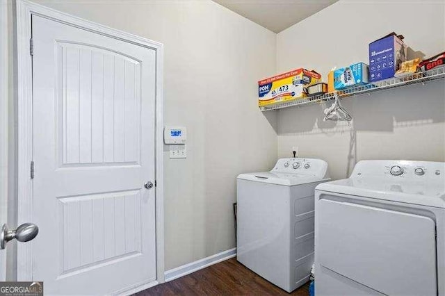 laundry area featuring separate washer and dryer and dark hardwood / wood-style floors