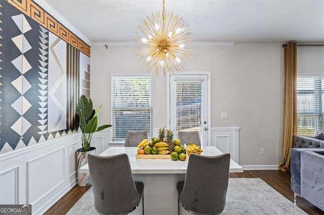 dining room with ornamental molding, dark hardwood / wood-style flooring, and a chandelier