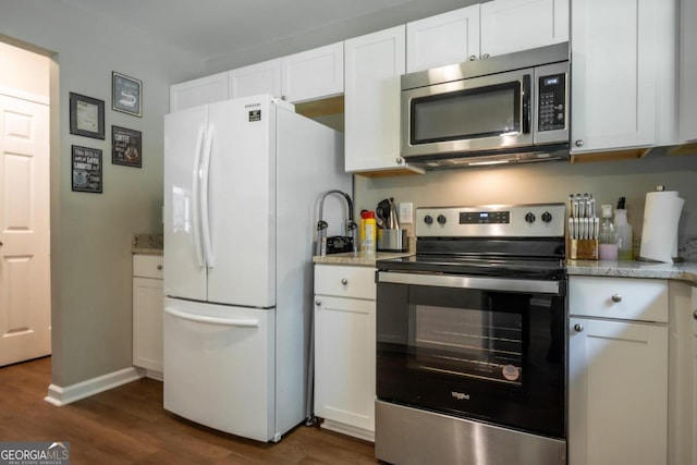 kitchen with dark hardwood / wood-style floors, white cabinets, and appliances with stainless steel finishes