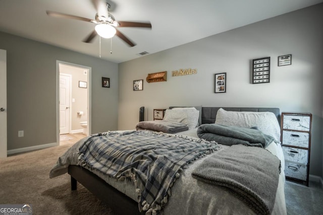 bedroom with ceiling fan, ensuite bathroom, and carpet flooring