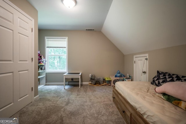 carpeted bedroom featuring lofted ceiling