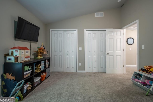 playroom featuring vaulted ceiling and carpet flooring