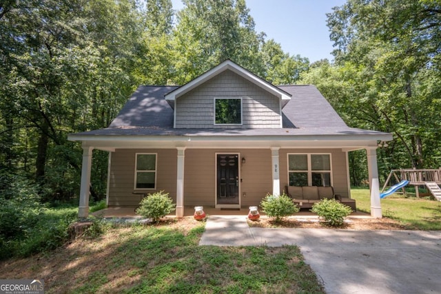 view of front of property with a porch and a playground