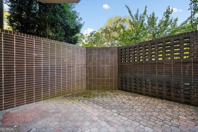 view of gate with a patio area