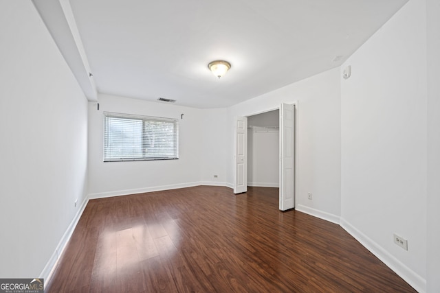 unfurnished bedroom featuring dark hardwood / wood-style floors