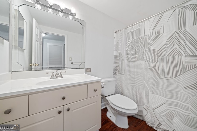 bathroom with vanity, hardwood / wood-style floors, and toilet