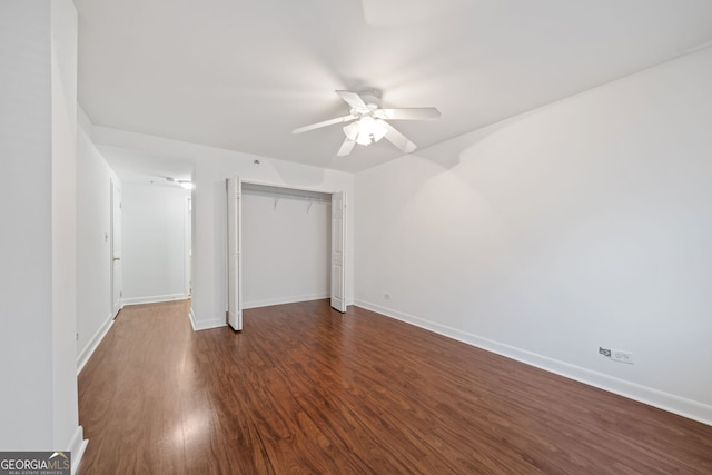 unfurnished bedroom with dark wood-type flooring, ceiling fan, and a closet