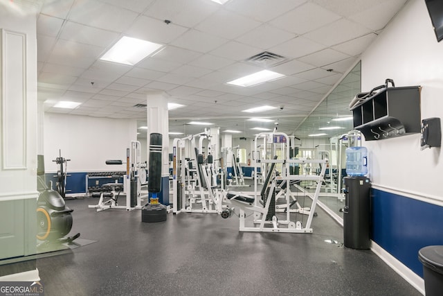 exercise room featuring a paneled ceiling