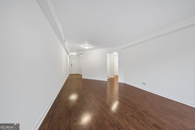 interior space featuring dark wood-type flooring and ornamental molding