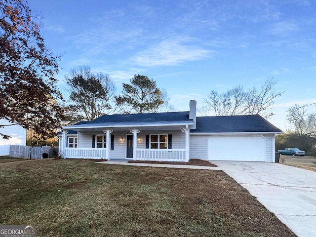 ranch-style home featuring a garage, covered porch, and a front lawn