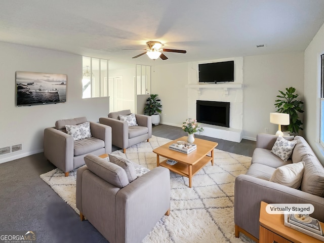 living room with a fireplace and ceiling fan