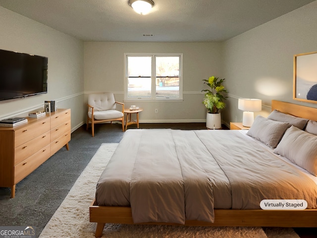 bedroom featuring dark colored carpet