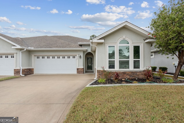 ranch-style house featuring a garage and a front lawn