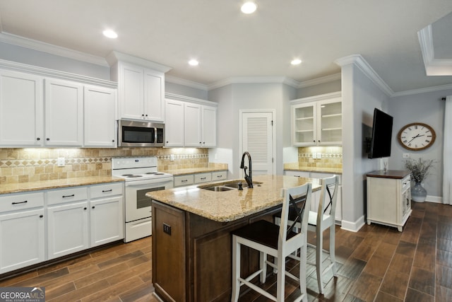 kitchen featuring white electric stove, sink, a center island with sink, and white cabinets