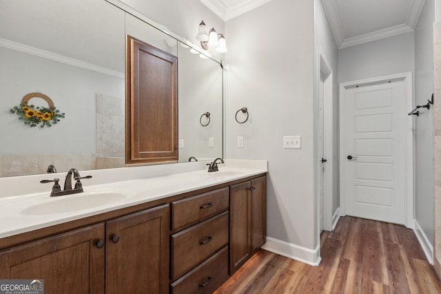 bathroom featuring hardwood / wood-style flooring, crown molding, and vanity